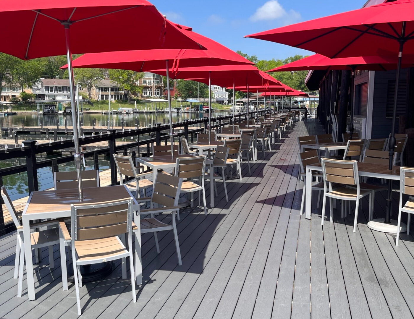 The outdoor view of Marina 27 Steak & Seafood with water and houses in the background.