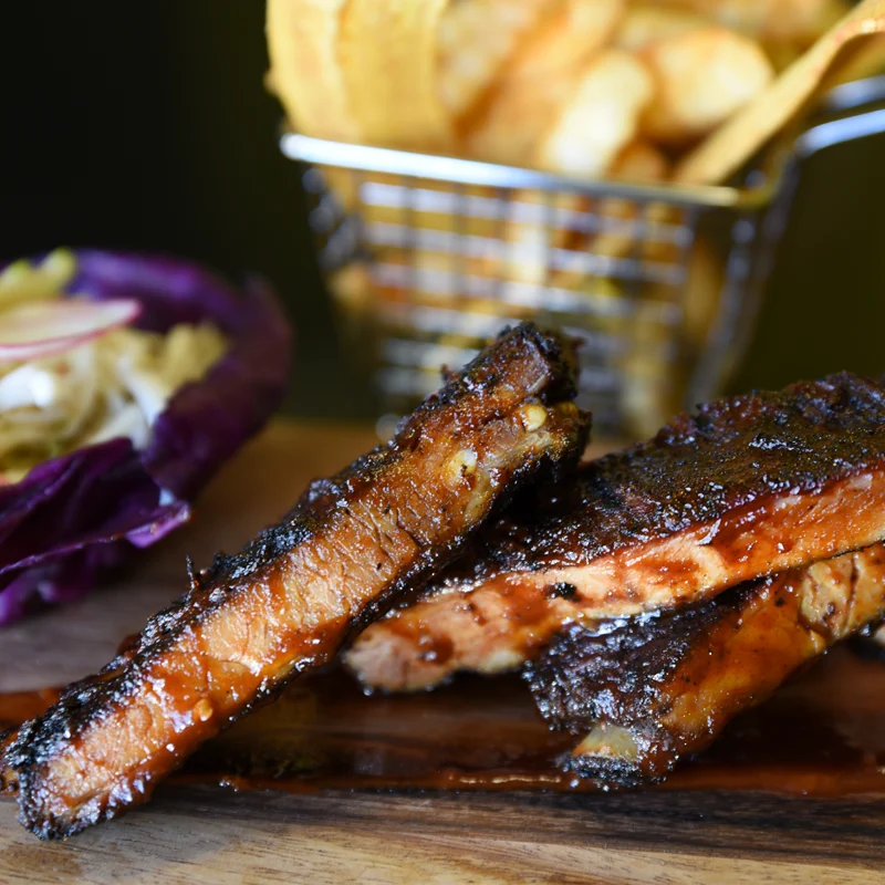 Barbecue pork ribs seasoned with a rub and glazed with a sticky BBQ sauce.