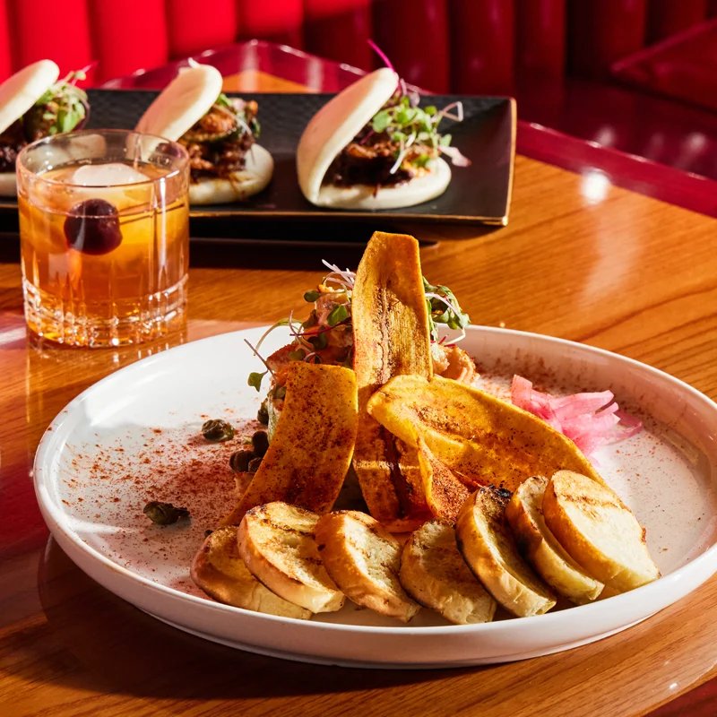 A caribbean dish from Black Garlic Restaurant with plantains covered by spices.