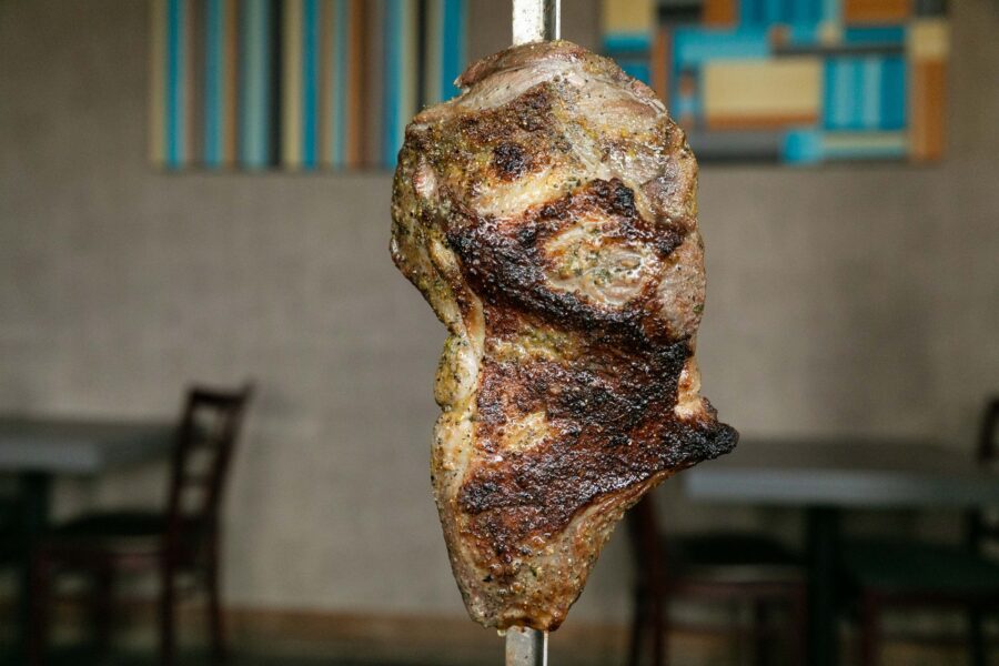 Grilled Cordeiro lamb from Em Chamas Brazilian Grill, with a nice char on the outside, served rodizio-style on a skewer.