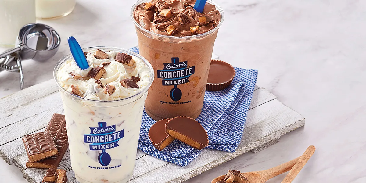 Two Culver's concrete mixers - one filled with chocolate and one filled with vanilla - both topped with delicious candy.