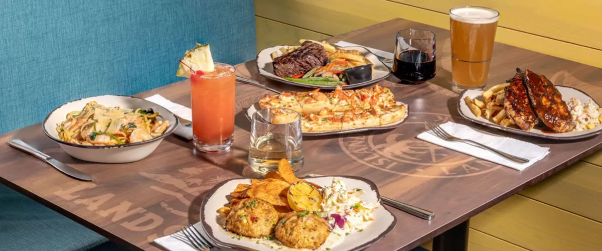 An array of surf and turf food, including chicken, steak, seafood entrees, and more.