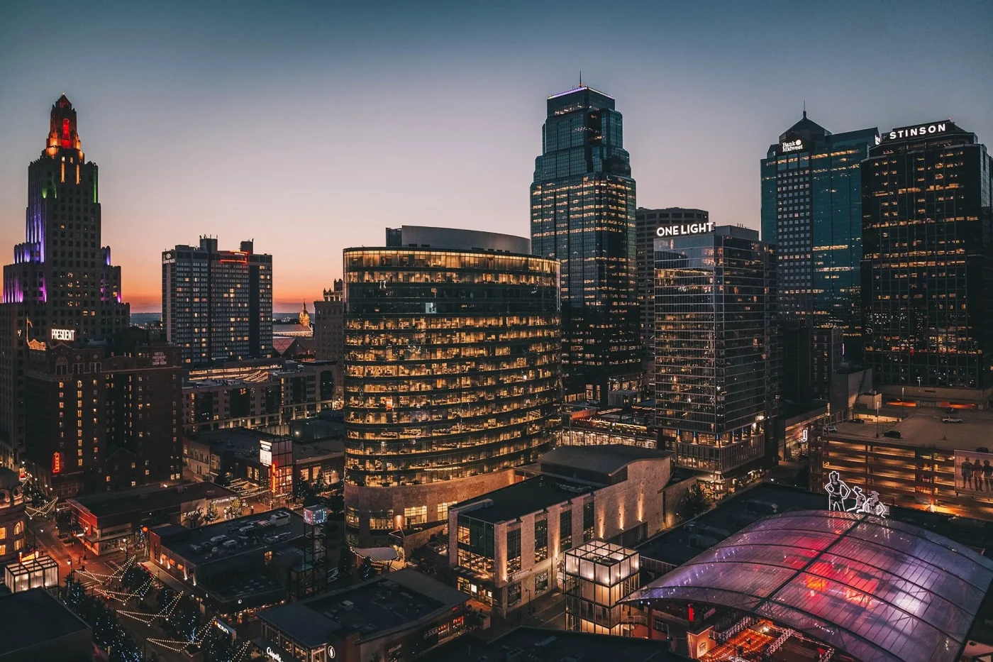 The Kansas City Skyline at dusk with buildings lit up throughout the city.